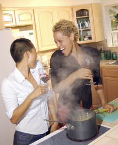 Happy women in kitchen with food cooking